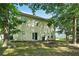 Back exterior of home with sliding glass door, patio, and mature trees at 5487 Walnut Lane Ln, Stonecrest, GA 30038
