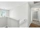 View of a bright upstairs hallway with carpeted floor, railing, and natural light at 5487 Walnut Lane Ln, Stonecrest, GA 30038
