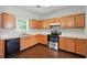 Spacious kitchen featuring wooden cabinets, stainless steel appliances, and dark wood flooring at 5487 Walnut Lane Ln, Stonecrest, GA 30038