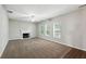Bright living room with fireplace, recessed lighting, ceiling fan and three windows at 5487 Walnut Lane Ln, Stonecrest, GA 30038