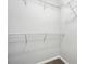 Image shows empty walk-in closet with white wire shelving and neutral walls at 5487 Walnut Lane Ln, Stonecrest, GA 30038