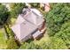 Aerial view showcasing the back of the home, multiple decks, and mature landscaping at 5600 Buck Hollow Dr, Alpharetta, GA 30005