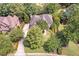 Aerial view of property featuring a manicured lawn, mature landscaping and a long driveway at 5600 Buck Hollow Dr, Alpharetta, GA 30005