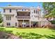 Expansive back exterior of home with multiple decks, lawn and mature landscaping at 5600 Buck Hollow Dr, Alpharetta, GA 30005