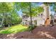 Beautiful back exterior view featuring multiple decks, lush lawn and mature trees at 5600 Buck Hollow Dr, Alpharetta, GA 30005