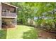 Picturesque backyard featuring multiple decks, a lush lawn, mature trees, and a swing at 5600 Buck Hollow Dr, Alpharetta, GA 30005