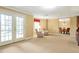 Large basement area with French doors, seating area, and dining area under warm lighting at 5600 Buck Hollow Dr, Alpharetta, GA 30005