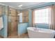 Bathroom featuring a soaking tub, walk-in shower, and neutral tile at 5600 Buck Hollow Dr, Alpharetta, GA 30005
