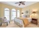 Serene bedroom with arched windows and a cozy sitting area at 5600 Buck Hollow Dr, Alpharetta, GA 30005