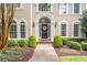 Elegant home entrance with a classic door, manicured landscaping, and a welcoming walkway at 5600 Buck Hollow Dr, Alpharetta, GA 30005