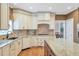 Modern kitchen with granite countertops, custom cabinets, stainless steel appliances, and hardwood floors at 5600 Buck Hollow Dr, Alpharetta, GA 30005
