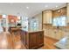 Spacious kitchen includes custom cabinets, granite countertops, island, and access to living area at 5600 Buck Hollow Dr, Alpharetta, GA 30005