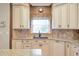 Bright kitchen featuring stylish backsplash, countertops, island and ample counter space at 5600 Buck Hollow Dr, Alpharetta, GA 30005