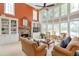 Inviting living room with a stone fireplace, built-in bookshelves, and large windows at 5600 Buck Hollow Dr, Alpharetta, GA 30005