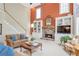 Cozy living room featuring a stone fireplace, and tall windows with natural light at 5600 Buck Hollow Dr, Alpharetta, GA 30005