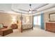 Spacious main bedroom with a tray ceiling, fan, and large window at 5600 Buck Hollow Dr, Alpharetta, GA 30005