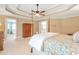 Spacious main bedroom featuring a ceiling fan, four-poster bed and ensuite bathroom at 5600 Buck Hollow Dr, Alpharetta, GA 30005