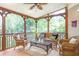 Inviting screened porch with wicker furniture and views of a lush, green landscape at 5600 Buck Hollow Dr, Alpharetta, GA 30005