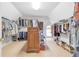 Large walk-in closet with built-in shelving and storage for clothing and shoes at 5600 Buck Hollow Dr, Alpharetta, GA 30005