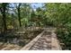 A wooden bridge crosses a small stream in the backyard with dense foliage along the banks at 119 Walker Nw Rd, Cartersville, GA 30121