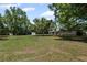 Expansive backyard showing the house, a shed, and mature trees under a blue sky on a sunny day at 119 Walker Nw Rd, Cartersville, GA 30121