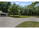 Wide backyard with a driveway, a sunroom, and mature trees offers potential at 119 Walker Nw Rd, Cartersville, GA 30121