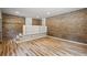 Finished basement with brick wall, built-in bookshelves, and hardwood floors at 119 Walker Nw Rd, Cartersville, GA 30121