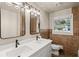Bathroom featuring double sinks, updated tile, modern fixtures, and a window for natural light at 119 Walker Nw Rd, Cartersville, GA 30121