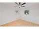 Well-lit bedroom with hardwood floors, ceiling fan, and new windows at 119 Walker Nw Rd, Cartersville, GA 30121