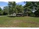 Ranch-style home featuring brick facade, screened-in porch, and a spacious front yard with mature trees providing shade at 119 Walker Nw Rd, Cartersville, GA 30121