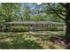 Charming brick ranch home with a well-manicured lawn, mature trees, and inviting walkway at 119 Walker Nw Rd, Cartersville, GA 30121