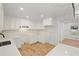 Bright kitchen features white cabinets, quartz countertops, and stainless steel appliances at 119 Walker Nw Rd, Cartersville, GA 30121