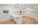 Modern kitchen with white cabinets, marble-style backsplash, quartz countertops, and hardwood floors at 119 Walker Nw Rd, Cartersville, GA 30121