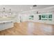 Open-concept layout with hardwood floors, connecting the living area and the white kitchen with bar seating at 119 Walker Nw Rd, Cartersville, GA 30121