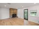 Cozy space with hardwood floors, a brick fireplace, and a view of the outdoors through a window at 119 Walker Nw Rd, Cartersville, GA 30121