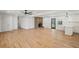 Spacious room featuring hardwood floors and a brick fireplace, connecting living spaces and the kitchen at 119 Walker Nw Rd, Cartersville, GA 30121