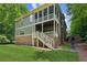 Exterior of a two-story home with a screened porch and large backyard with a green lawn at 328 Shade Tree Cir, Woodstock, GA 30188