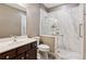 Bathroom features a marble enclosed shower, toilet, and vanity at 328 Shade Tree Cir, Woodstock, GA 30188