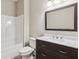 Modern bathroom featuring a white tub, toilet, and dark wood vanity with a marble countertop at 328 Shade Tree Cir, Woodstock, GA 30188