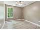 Cozy bedroom with ceiling fan and natural light from the large window at 328 Shade Tree Cir, Woodstock, GA 30188