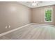 Spacious bedroom featuring plush carpet, a ceiling fan, and large window at 328 Shade Tree Cir, Woodstock, GA 30188