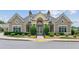 Community clubhouse exterior with manicured landscaping and sidewalk access at 328 Shade Tree Cir, Woodstock, GA 30188