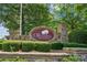 Stone community entrance sign for 'The Orchards of East Cherokee' surrounded by manicured landscaping at 328 Shade Tree Cir, Woodstock, GA 30188