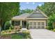 Charming single-story home with a well-manicured lawn, mature trees and a two car garage at 328 Shade Tree Cir, Woodstock, GA 30188