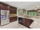 Spacious kitchen features stainless steel refrigerator and granite countertops at 328 Shade Tree Cir, Woodstock, GA 30188