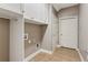 Functional laundry room with cabinets, a hanging rod and ceramic tile floors at 328 Shade Tree Cir, Woodstock, GA 30188