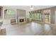Open living room with a gas fireplace, built-in bookshelves, neutral paint and access to the backyard at 328 Shade Tree Cir, Woodstock, GA 30188