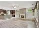 Bright and airy living room is open to the kitchen and features a gas fireplace at 328 Shade Tree Cir, Woodstock, GA 30188