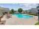 A refreshing community swimming pool is surrounded by lounge chairs and manicured landscaping at 328 Shade Tree Cir, Woodstock, GA 30188