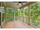 Charming screened porch with wood flooring and views of lush green trees at 328 Shade Tree Cir, Woodstock, GA 30188